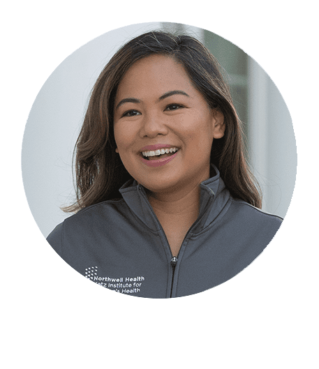 Woman in a Northwell half-zip smiling